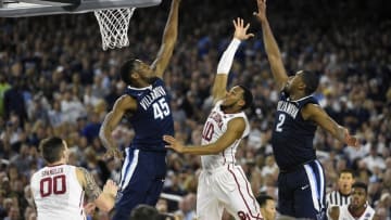 Apr 2, 2016; Houston, TX, USA; Oklahoma Sooners guard Jordan Woodard (10) puts up a shot defended by Villanova Wildcats forward Darryl Reynolds (45) and Kris Jenkins (2) during the second half in the 2016 NCAA Men