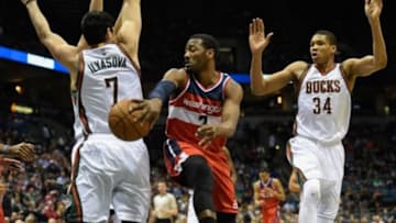Mar 7, 2015; Milwaukee, WI, USA; Washington Wizards guard John Wall (2) passes the ball around Milwaukee Bucks forward Ersan Ilyasova (7) and forward Giannis Antetokounmpo (34) in the first quarter at BMO Harris Bradley Center. Mandatory Credit: Benny Sieu-USA TODAY Sports