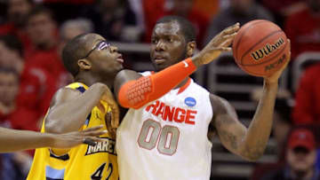 CLEVELAND, OH - MARCH 20: Rick Jackson #00 of the Syracuse Orange handles the ball against Chris Otule #42 of the Marquette Golden Eagles during the third of the 2011 NCAA men's basketball tournament at Quicken Loans Arena on March 20, 2011 in Cleveland, Ohio. (Photo by Andy Lyons/Getty Images)