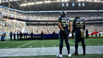 Nov 21, 2021; Seattle, Washington, USA; Seattle Seahawks middle linebacker Bobby Wagner (54) and Seattle Seahawks outside linebacker Jordyn Brooks (56) during the National Anthem prior to the game against the Arizona Cardinals. Arizona defeated Seattle 23-13. Mandatory Credit: Steven Bisig-USA TODAY Sports