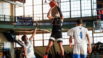 Detroit Douglass' Pierre Brooks II (1) makes a jump shot against Pershing's Avant Lance (12) during the second half of a MHSAA regular season game at Detroit Pershing High School in Detroit, on Friday, March 5, 2021.