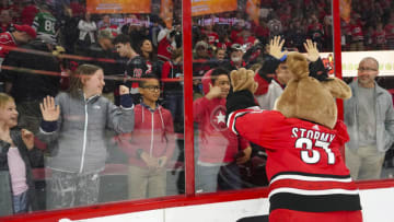Mar 23, 2019; Raleigh, NC, USA; Carolina Hurricanes mascot stormy celebrates with the fan after the game against the Minnesota Wild at PNC Arena. The Carolina Hurricanes defeated the Minnesota Wild 5-1. Mandatory Credit: James Guillory-USA TODAY Sports
