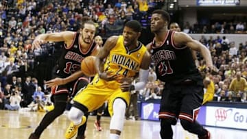 Mar 21, 2014; Indianapolis, IN, USA; Indiana Pacers forward Paul George (24) is stripped of the ball by Chicago Bulls forward Joakim Noah (13) at Bankers Life Fieldhouse. Indiana defeats Chicago 91-79. Mandatory Credit: Brian Spurlock-USA TODAY Sports