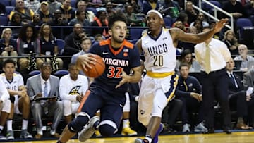 Nov 11, 2016; Greensboro, NC, USA; Virginia Cavaliers guard London Perrantes (32) drives to the basket guarded by UNC-Greensboro Spartans guard Diante Baldwin (20) at Greensboro Coliseum. Mandatory Credit: Jim Dedmon-USA TODAY Sports