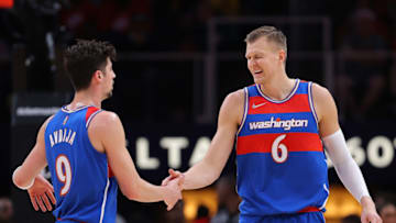 ATLANTA, GEORGIA - APRIL 06: Kristaps Porzingis #6 of the Washington Wizards reacts after hitting a three-point basket against the Atlanta Hawks with Deni Avdija #9 during the first half at State Farm Arena on April 06, 2022 in Atlanta, Georgia. NOTE TO USER: User expressly acknowledges and agrees that, by downloading and or using this photograph, User is consenting to the terms and conditions of the Getty Images License Agreement. (Photo by Kevin C. Cox/Getty Images)