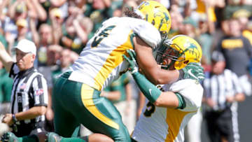IOWA CITY, IOWA- SEPTEMBER 17: Strong Safety Robbie Grimsley #5 of the North Dakota State Bisons celebrates with defensive end Greg Menard #96 after a sack in the fourth quarter against the Iowa Hawkeyes on September 17, 2016 at Kinnick Stadium in Iowa City, Iowa. (Photo by Matthew Holst/Getty Images)