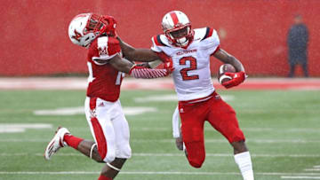 Sep 17, 2016; Oxford, OH, USA; Miami (Oh) Redhawks defensive back Tony Reid (14) is stiff armed by Western Kentucky Hilltoppers wide receiver Taywan Taylor (2) in the first half at Fred Yager Stadium. Mandatory Credit: Aaron Doster-USA TODAY Sports