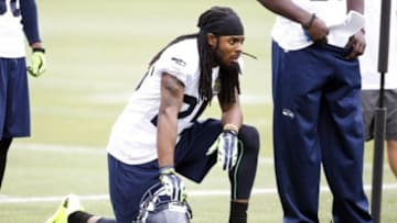 Jun 17, 2014; Renton, WA, USA; Seattle Seahawks cornerback Richard Sherman (25) rests on the sideline during a minicamp scrimmage at the Virginia Mason Athletic Center. Mandatory Credit: Joe Nicholson-USA TODAY Sports