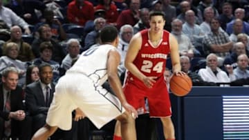 Feb 18, 2015; University Park, PA, USA; Wisconsin Badgers guard Bronson Koenig (24) dribbles the ball as Penn State Nittany Lions forward Payton Banks (0) defends during the second half at Bryce Jordan Center. Wisconsin defeated Penn State 55-47. Mandatory Credit: Matthew O