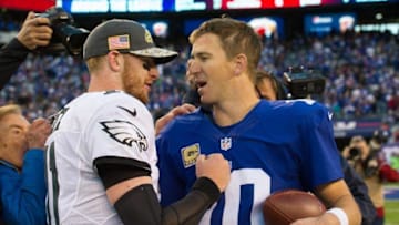 Nov 6, 2016; East Rutherford, NJ, USA; Philadelphia Eagles quarterback Carson Wentz (11) and New York Giants quarterback Eli Manning (10) talk after their game at MetLife Stadium. The Giants won 28-23. Mandatory Credit: William Hauser-USA TODAY Sports