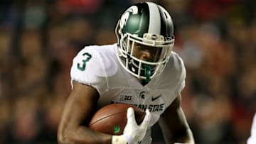 PISCATAWAY, NJ - OCTOBER 10: LJ Scott #3 of the Michigan State Spartans carries the ball in the fourth quarter against the Rutgers Scarlet Knights on October 10, 2015 at High Point Solutions Stadium in Piscataway, New Jersey.The Michigan State Spartans defeated the Rutgers Scarlet Knights 31-24. (Photo by Elsa/Getty Images)