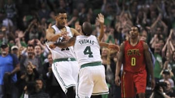 Apr 24, 2016; Boston, MA, USA; Boston Celtics guard Evan Turner (11) and guard Isaiah Thomas (4) react after Thomas made a three point shot during overtime in game four of the first round of the NBA Playoffs agains the Atlanta Hawks at TD Garden. Mandatory Credit: Bob DeChiara-USA TODAY Sports