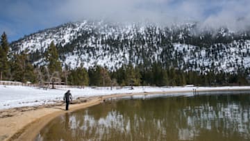 SAND HARBOR, NV - JANUARY 31: Visitors to Lake Tahoe walk along the snow-free shoreline on January 31, 2017, in Sand Harbor, Nevada. The six-year drought in California and Nevada has been called off by the Federal government following record rain throughout the states and up to 25 feet of snow in the Sierra Nevada Mountain Range. (Photo by George Rose/Getty Images)