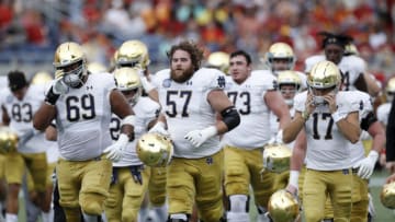 ORLANDO, FL - DECEMBER 28: Notre Dame Fighting Irish players head to the locker room after warming up prior to the Camping World Bowl against the Iowa State Cyclones at Camping World Stadium on December 28, 2019 in Orlando, Florida. Notre Dame defeated Iowa State 33-9. (Photo by Joe Robbins/Getty Images)