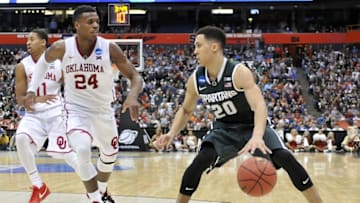 Mar 27, 2015; Syracuse, NY, USA; Michigan State Spartans guard Travis Trice (20) handles the ball against Oklahoma Sooners guard Buddy Hield (24) during the second half in the semifinals of the east regional of the 2015 NCAA Tournament at Carrier Dome. Mandatory Credit: Mark Konezny-USA TODAY Sports