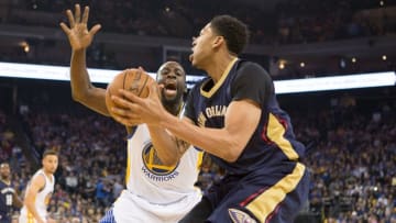 Mar 14, 2016; Oakland, CA, USA; New Orleans Pelicans forward Anthony Davis (23) dribbles the ball as Golden State Warriors forward Draymond Green (23) defends in the first quarter at Oracle Arena. Mandatory Credit: Neville E. Guard-USA TODAY Sports