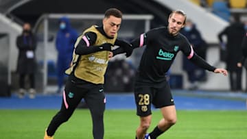 Barcelona's Spanish defender Oscar Mingueza (R) and Barcelona's US defender Sergino Dest. (Photo by SERGEI SUPINSKY/AFP via Getty Images)