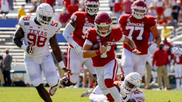 Oct 10, 2020; Dallas, Texas, USA; Oklahoma Sooners quarterback Spencer Rattler (7) is tackled from behind by Texas Longhorns linebacker Joseph Ossai (46) during the first quarter of the Red River Showdown at Cotton Bowl. Mandatory Credit: Andrew Dieb-USA TODAY Sports
