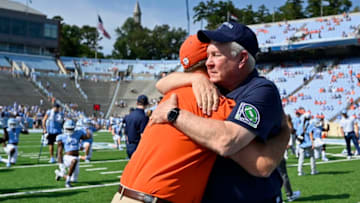 CHAPEL HILL, NORTH CAROLINA - SEPTEMBER 28: Head coach Mack Brown of the North Carolina Tar Heels hugs head coach Dabo Swinney of the Clemson Tigers before their game at Kenan Stadium on September 28, 2019 in Chapel Hill, North Carolina. (Photo by Grant Halverson/Getty Images)
