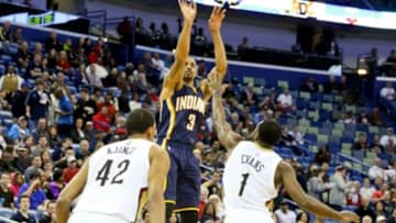 Feb 11, 2015; New Orleans, LA, USA; Indiana Pacers guard George Hill (3) shoots over New Orleans Pelicans guard Tyreke Evans (1) and center Alexis Ajinca (42) during the first half of a game at the Smoothie King Center. The Pacers defeated the Pelicans 106-93.Mandatory Credit: Derick E. Hingle-USA TODAY Sports