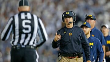 STATE COLLEGE, PA - OCTOBER 21: Head coach Jim Harbaugh of the Michigan Wolverines talks with a referee in the first half against the Penn State Nittany Lions on October 21, 2017 at Beaver Stadium in State College, Pennsylvania. (Photo by Justin K. Aller/Getty Images)