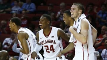 Jan 28, 2015; Norman, OK, USA; Oklahoma Sooners guard Isaiah Cousins (11), guard Buddy Hield (24), forward TaShawn Thomas (35), and forward Ryan Spangler (00) react to a play against the Texas Tech Red Raiders during the second half at Lloyd Noble Center. Oklahoma won 81-36. Mandatory Credit: Alonzo Adams-USA TODAY Sports