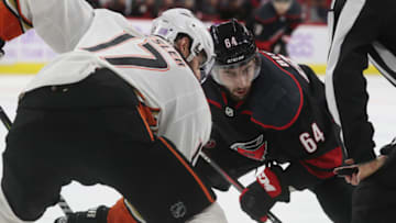 RALEIGH, NC - NOVEMBER 30: Clark Bishop #64 of the Carolina Hurricanes prepares for a faceoff with Ryan Kesler #17 of the Anaheim Ducks during an NHL game on November 30, 2018 at PNC Arena in Raleigh, North Carolina. (Photo by Gregg Forwerck/NHLI via Getty Images)