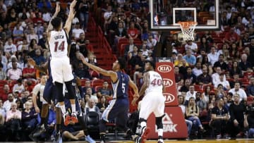 Dec 13, 2015; Miami, FL, USA; Miami Heat guard Gerald Green (14) makes a three point basket as Memphis Grizzlies guard Courtney Lee (5) looks on during the first half at American Airlines Arena. Mandatory Credit: Steve Mitchell-USA TODAY Sports