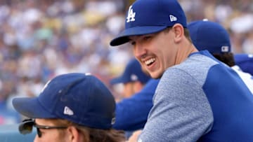 LOS ANGELES, CA - OCTOBER 01: Walker Buehler #21 of the Los Angeles Dodgers laughs with Clayton Kershaw #22 in the dugout, in the eighth inning, during a 5-2 win over the Colorado Rockies during the National League West tiebreaker game at Dodger Stadium on October 1, 2018 in Los Angeles, California. (Photo by Harry How/Getty Images)