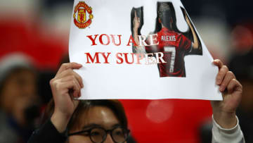LONDON, ENGLAND - JANUARY 31: A Manchester United fan holds up an Alexis Sanchez poster prior to the Premier League match between Tottenham Hotspur and Manchester United at Wembley Stadium on January 31, 2018 in London, England. (Photo by Julian Finney/Getty Images)