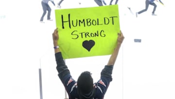 WINNIPEG, MB - APRIL 7: A fan holds up a sign in support of the Humboldt Broncos during third period action between the Winnipeg Jets and the Chicago Blackhawks at the Bell MTS Place on April 7, 2018 in Winnipeg, Manitoba, Canada. The Broncos lost members of their team in a motor vehicle accident on April 6, 2018.The Jets defeated the Bruins 5-4 in the shootout. (Photo by Jonathan Kozub/NHLI via Getty Images)