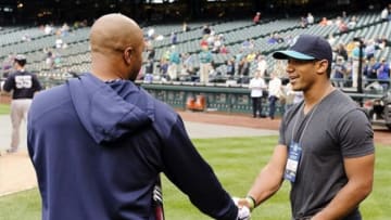 Jun 7, 2013; Seattle, WA, USA; New York Yankees left fielder Vernon Wells (12) (left) and Seattle Seahawks quarterback Russell Wilson (right) talk prior to the game between the Seattle Mariners and the New York Yankees at Safeco Field. Mandatory Credit: Steven Bisig-USA TODAY Sports