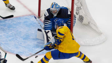 EDMONTON, AB - JANUARY 02: Lucas Raymond #18 of Sweden takes a shot against goaltender Kari Piiroinen #1 of Finland during the 2021 IIHF World Junior Championship quarterfinals at Rogers Place on January 2, 2021 in Edmonton, Canada. (Photo by Codie McLachlan/Getty Images)