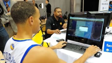 December 12, 2011; Oakland, CA, USA; Golden State Warriors point guard Stephen Curry (front) types on the computer for Twitter with head coach Mark Jackson (back) during media day at the Golden State Warriors Practice Facility. Mandatory Credit: Kyle Terada-USA TODAY Sports