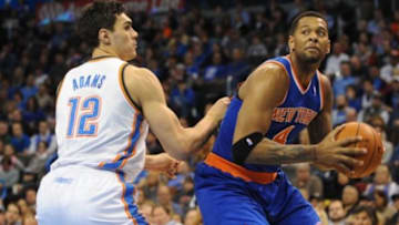 Feb 9, 2014; Oklahoma City, OK, USA; New York Knicks power forward Jeremy Tyler (4) holds the ball as Oklahoma City Thunder center Steven Adams (12) defends during the second quarter at Chesapeake Energy Arena. Mandatory Credit: Mark D. Smith-USA TODAY Sports