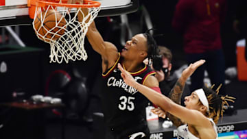 Jan 11, 2021; Cleveland, Ohio, USA; Cleveland Cavaliers guard Isaac Okoro (35) dunks the ball while defended by Memphis Grizzlies forward Brandon Clarke (15) during the second half at Rocket Mortgage FieldHouse. Mandatory Credit: Ken Blaze-USA TODAY Sports