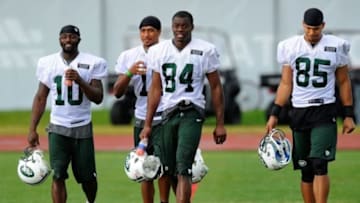 July 28, 2012; Cortland, NY, USA; New York Jets wide receivers Santonio Holmes (10) Royce Pollard (18) Stephen Hill (84) and Chaz Schilens (85) walk off the field following training camp at SUNY Cortland. Mandatory Credit: Rich Barnes-USA TODAY Sports