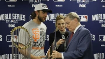Oct 29, 2014; Kansas City, MO, USA; MLB commissioner Bud Selig presents San Francisco Giants pitcher Madison Bumgarner with the MVP trophy next to the Commissioners Trophy after game seven of the 2014 World Series against the Kansas City Royals at Kauffman Stadium. Mandatory Credit: Charlie Neibergall/Pool Photo via USA TODAY Sports