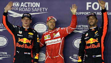SINGAPORE - SEPTEMBER 16: Top three qualifiers Sebastian Vettel of Germany and Ferrari, Max Verstappen of Netherlands and Red Bull Racing and Daniel Ricciardo of Australia and Red Bull Racing in parc ferme during qualifying for the Formula One Grand Prix of Singapore at Marina Bay Street Circuit on September 16, 2017 in Singapore. (Photo by Mark Thompson/Getty Images)