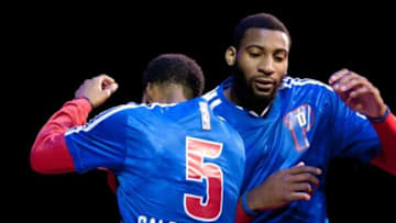 Nov 27, 2013; Auburn Hills, MI, USA; Detroit Pistons shooting guard Kentavious Caldwell-Pope (5) and Andre Drummond (0) bump shoulders before the game against the Chicago Bulls at The Palace of Auburn Hills. Bulls beat the Pistons 99-79. Mandatory Credit: Raj Mehta-USA TODAY Sports