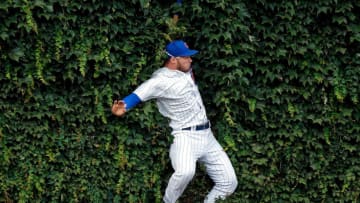 CHICAGO, IL - AUGUST 15: Ian Happ #8 of the Chicago Cubs makes a leaping catch for an out against the Milwaukee Brewers and collides with the outfield wall during the ninth inning at Wrigley Field on August 15, 2018 in Chicago, Illinois. The Chicago Cubs won 8-4. (Photo by Jon Durr/Getty Images)