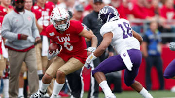 Sep 28, 2019; Madison, WI, USA; Wisconsin Badgers wide receiver Danny Davis III (6) rushes with the football as Northwestern Wildcats defensive back Cameron Ruiz (18) defends during the third quarter at Camp Randall Stadium. Mandatory Credit: Jeff Hanisch-USA TODAY Sports