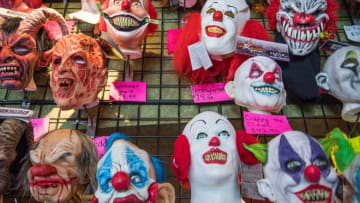 Halloween masks adorn the wall of a costume shop in Annapolis, Maryland, on October 16, 2018. (Photo by Jim WATSON / AFP) (Photo credit should read JIM WATSON/AFP/Getty Images)