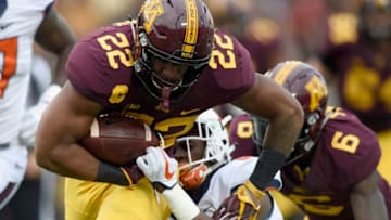 MINNEAPOLIS, MN - OCTOBER 21: Kobe McCrary #22 of the Minnesota Golden Gophers carries the ball against Nate Hobbs #8 of the Illinois Fighting Illini during the first quarter of the game on October 21, 2017 at TCF Bank Stadium in Minneapolis, Minnesota. The Golden Gophers defeated the Fighting Illini 24-17. (Photo by Hannah Foslien/Getty Images)