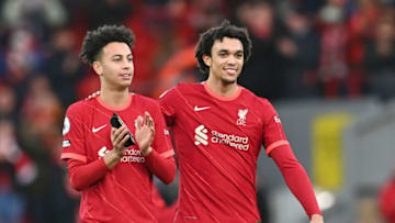 Liverpool's English striker Kaide Gordon (L) and Liverpool's English defender Trent Alexander-Arnold applauds the fans following the English Premier League football match between Liverpool and Brentford at Anfield in Liverpool, north west England on January 16, 2022. - Liverpool won the match 3-0. - RESTRICTED TO EDITORIAL USE. No use with unauthorized audio, video, data, fixture lists, club/league logos or 'live' services. Online in-match use limited to 120 images. An additional 40 images may be used in extra time. No video emulation. Social media in-match use limited to 120 images. An additional 40 images may be used in extra time. No use in betting publications, games or single club/league/player publications. (Photo by Paul ELLIS / AFP) / RESTRICTED TO EDITORIAL USE. No use with unauthorized audio, video, data, fixture lists, club/league logos or 'live' services. Online in-match use limited to 120 images. An additional 40 images may be used in extra time. No video emulation. Social media in-match use limited to 120 images. An additional 40 images may be used in extra time. No use in betting publications, games or single club/league/player publications. / RESTRICTED TO EDITORIAL USE. No use with unauthorized audio, video, data, fixture lists, club/league logos or 'live' services. Online in-match use limited to 120 images. An additional 40 images may be used in extra time. No video emulation. Social media in-match use limited to 120 images. An additional 40 images may be used in extra time. No use in betting publications, games or single club/league/player publications. (Photo by PAUL ELLIS/AFP via Getty Images)