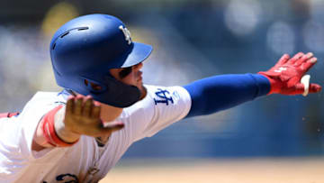 LOS ANGELES, CALIFORNIA - JUNE 23: Alex Verdugo #27 of the Los Angeles Dodgers reacts to his slide at first base despite being called out to end the third inning against the Colorado Rockies at Dodger Stadium on June 23, 2019 in Los Angeles, California. (Photo by Harry How/Getty Images)