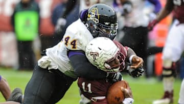 Nov 1, 2014; Philadelphia, PA, USA; East Carolina Pirates linebacker Zeek Bigger (44) tackles Temple Owls quarterback P.J. Walker (11) during the third quarter at Lincoln Financial Field. The Owls won the game 20-10. Mandatory Credit: John Geliebter-USA TODAY Sports