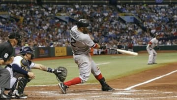Sep 11, 2013; St. Petersburg, FL, USA; Boston Red Sox first baseman Mike Napoli (12) hits a 2-run RBI double during the third inning against the Tampa Bay Rays at Tropicana Field. Mandatory Credit: Kim Klement-USA TODAY Sports