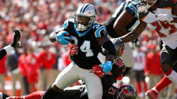 TAMPA, FL - OCTOBER 29: Running back Cameron Artis-Payne #34 of the Carolina Panthers is brought down by middle linebacker Kwon Alexander #58 of the Tampa Bay Buccaneers and strong safety Justin Evans #21 on a 3-yard gain for a first down during the first quarter of an NFL football game on October 29, 2017 at Raymond James Stadium in Tampa, Florida. (Photo by Brian Blanco/Getty Images)