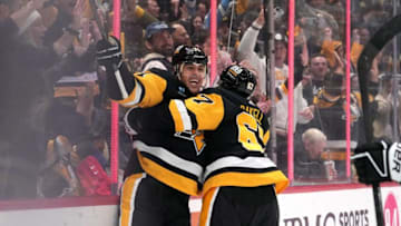 PITTSBURGH, PENNSYLVANIA - OCTOBER 14: Evgeni Malkin (L) #71 of the Pittsburgh Penguins celebrates a goal with Rickard Rakell #67 of the Pittsburgh Penguins during the third period against the Calgary Flames at PPG PAINTS Arena on October 14, 2023 in Pittsburgh, Pennsylvania. (Photo by Jason Mowry/Getty Images)